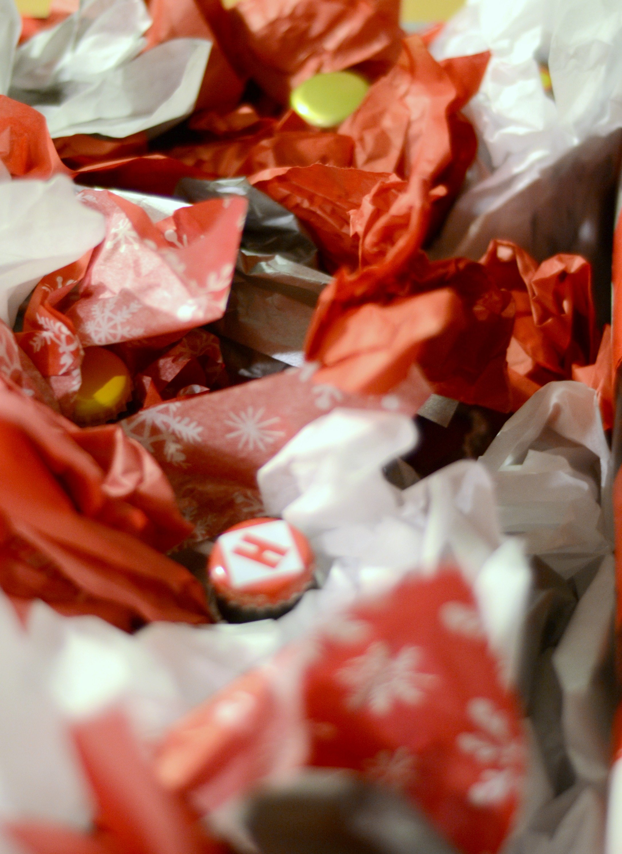 A bunch of tissue paper with the tops of beer bottles sticking out