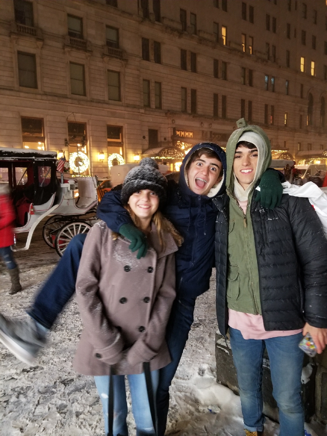 three teenagers bundled up in warm jackets in new york city
