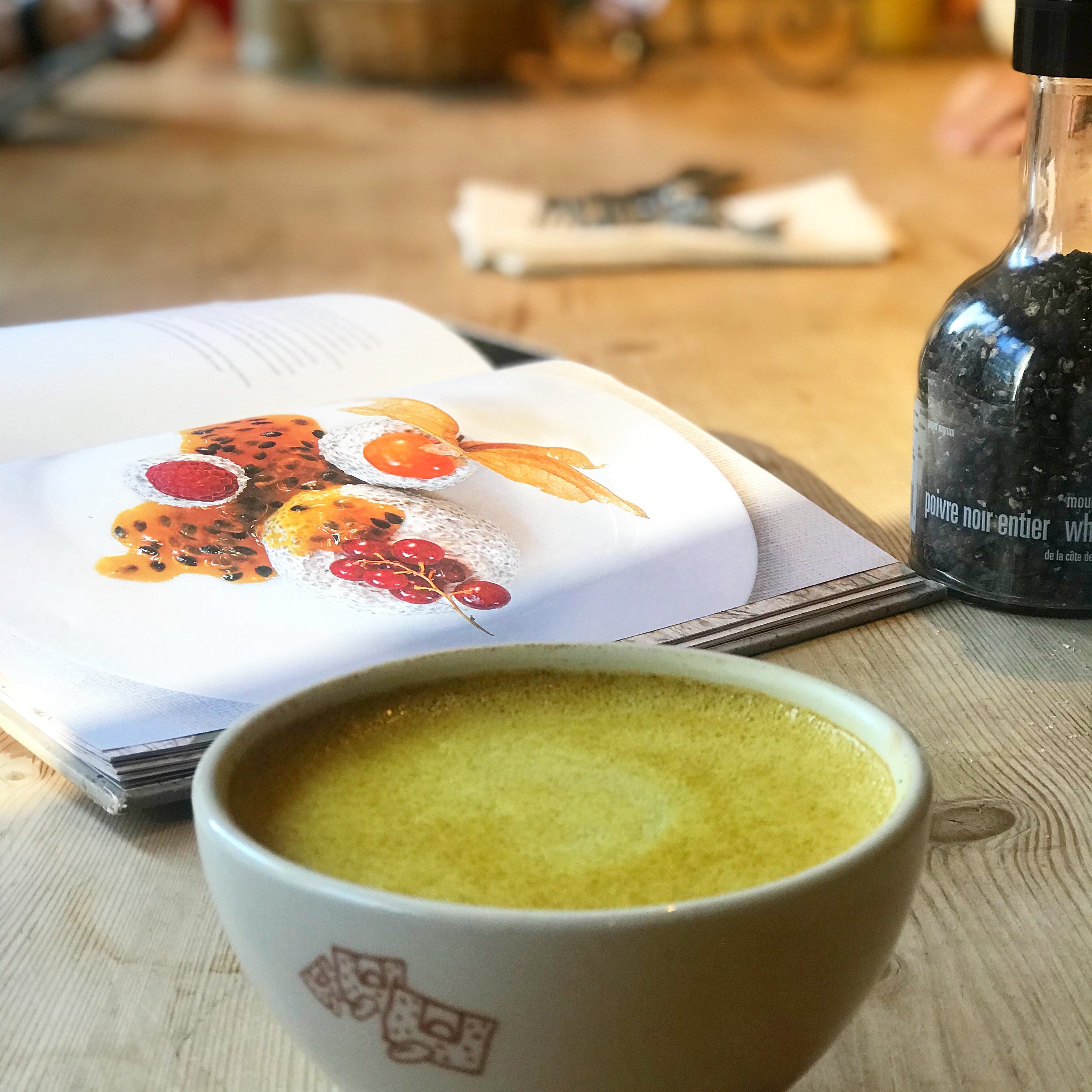 tumeric latte with an open cookbook in the background