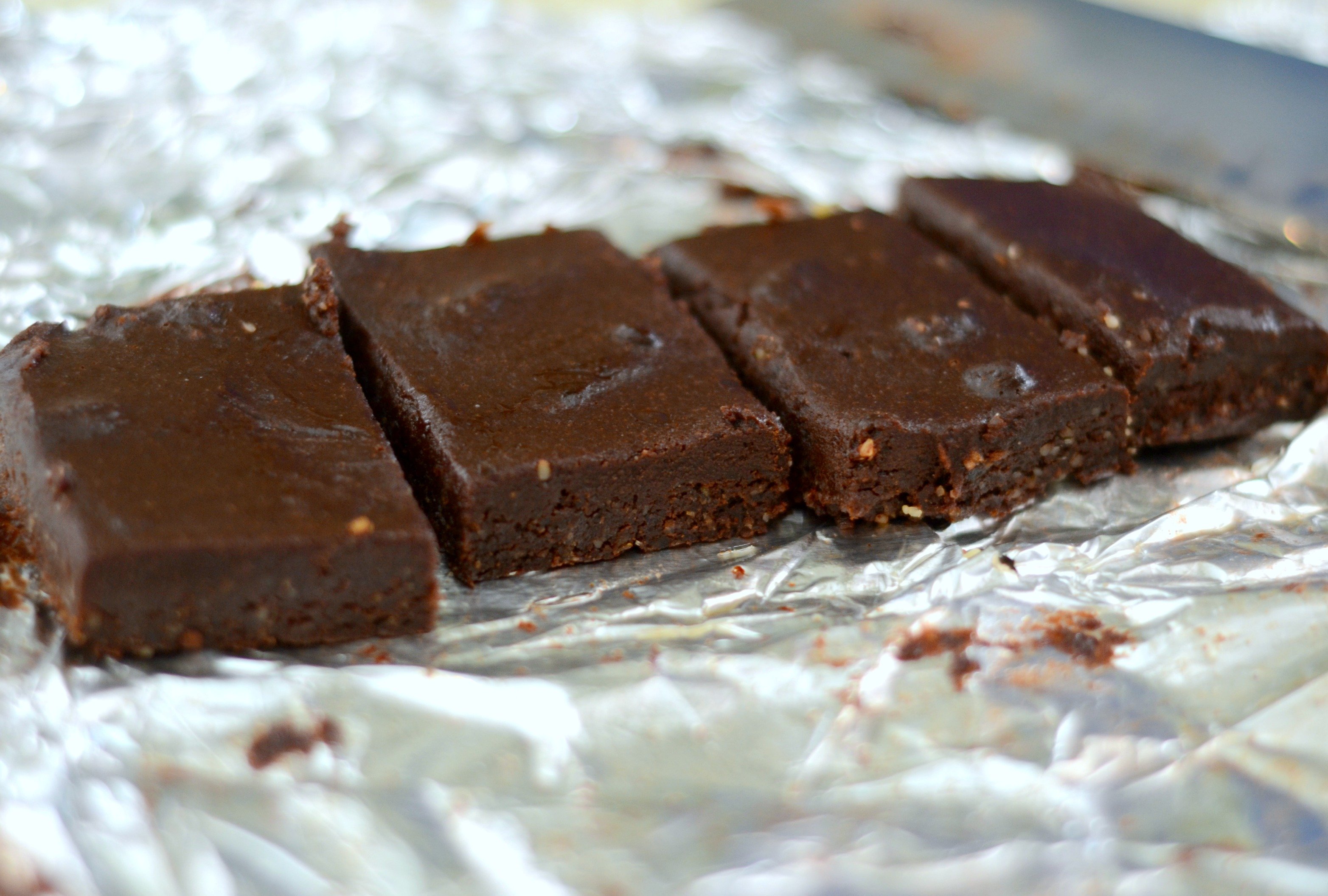 Four Vegan Raw Brownies on a tinfoil background