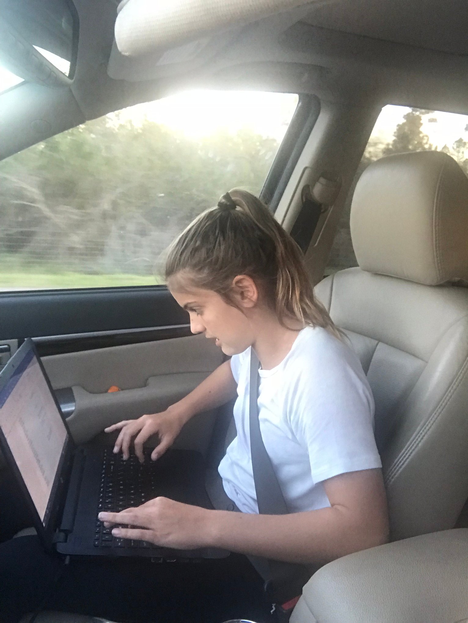 gymnasts doing homework in the car