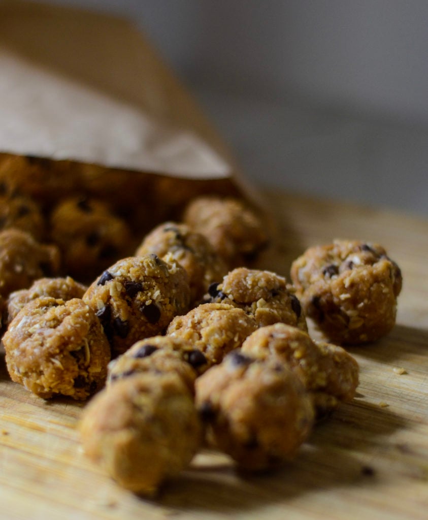 peanut butter protein balls in brown paper bag