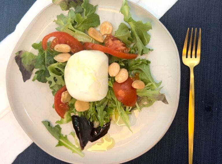 plate of greens with buratta cheese
